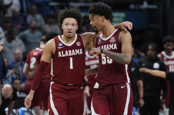 Alabama guard Mark Sears (1) hugs guard Aaron Estrada (55) during the second half of a Sweet 16 college basketball game against North Carolina in the NCAA tournament Thursday, March 28, 2024, in Los Angeles. (AP Photo/Ryan Sun)