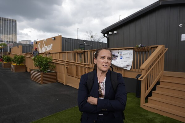 Cathryn Vassell, CEO of Partners for Home, speaks at the Melody Friday, April 12, 2024, in Atlanta. The Melody is a housing complex made from shipping containers and is intended to help house people from Atlanta's homeless population. (AP Photo/John Bazemore)