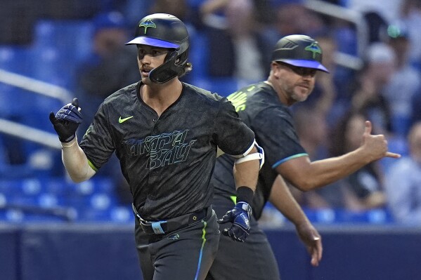Tampa Bay Rays' Jonny DeLuca, left, celebrates his two-run home run off Chicago White Sox relief pitcher Jared Shuster with third base coach Brady Williams during the fifth inning of a baseball game Monday, May 6, 2024, in St. Petersburg, Fla. (AP Photo/Chris O'Meara)