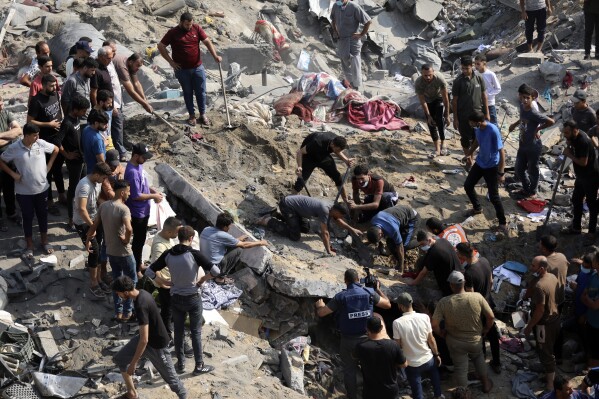 Palestinians work among debris of buildings that were targeted by Israeli airstrikes in Jabaliya refugee camp, northern Gaza Strip, Wednesday, Nov. 1, 2023. (AP Photo/Abed Khaled)