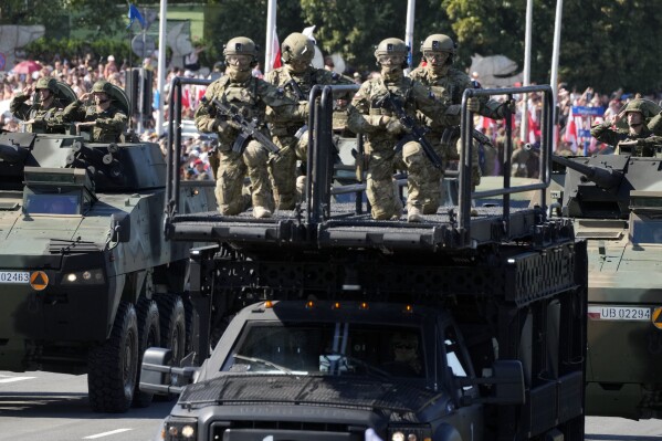 Polish troops take part in a massive military parade to celebrate the Polish Army Day, commemorating the 1920 battle in which Polish troops defeated advancing Bolshevik forces, in Warsaw, Poland, Tuesday, Aug. 15, 2023. Poland is holding a military parade to showcase its state-of-the-art weapons and defense systems, as war rages across its southeastern border in neighboring Ukraine and ahead of parliamentary elections scheduled for Oct. 15. (AP Photo/Czarek Sokolowski)
