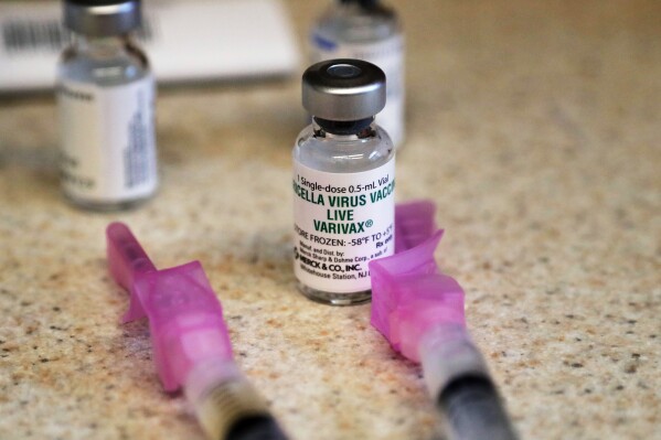 FILE - A chickenpox (also known as varicella) vaccine sits next to syringes and ready for a student at a free immunization clinic at a Seattle public school on Dec. 30, 2019, in Seattle. An expert scientific committee advising the British government said for the first time Tuesday Nov. 14, 2023 that children should be immunized with the chickenpox vaccine decades after the shots were made widely available in other rich countries, including the U.S., Canada and Australia. (AP Photo/Elaine Thompson, File)