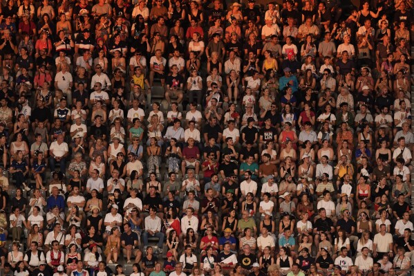 Spectators wait for the start of the 2024 Summer Olympics closing ceremony at the Stade de France, Sunday, Aug. 11, 2024, in Saint-Denis, France. (AP Photo/David Goldman)