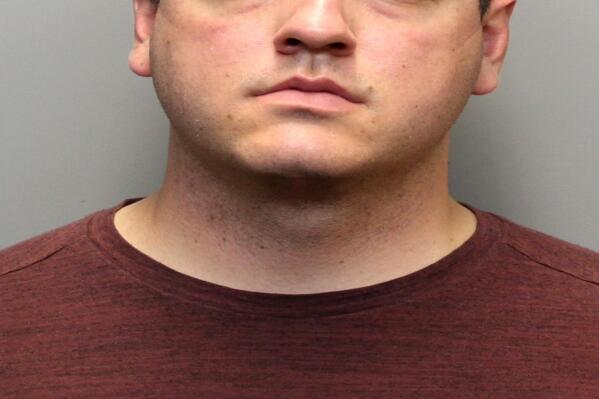 In this undated photo provided by the Larimer County Sheriff's Office, Austin Hopp is seen in a booking photo in Fort Collins, Colo. Hopp is one of two former police officers facing criminal charges over the rough arrest of a woman with dementia last year. (Larimer County Sheriff's Office via AP)