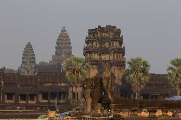FILE - This photo shows a view from outside Angkor Wat temple in Siem Reap, northwestern Cambodia, on March 3, 2018. Cambodia is rejecting allegations it violated international law by evicting people living around its famous Angkor Wat temple complex, saying in a report released Monday, March 4, 2024, by UNESCO that it was only relocating squatters and not residents of more than 100 traditional villages. (AP Photo/Heng Sinith, File)