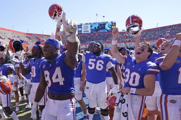 Florida players celebrate in front of fans after defeating Missouri in an NCAA college football game, Saturday, Oct. 8, 2022, in Gainesville, Fla. (AP Photo/John Raoux)