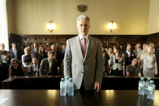 FILE - In this Tuesday, June 25, 2019 file photo, Ukrainian oligarch Dymitro Firtash waits for the start of his trial at the Austrian supreme court in Vienna, Austria. Austrian officials say the country’s justice minister has approved the extradition to the U.S. of Firtash, but his defense has filed a court application to reopen the case and he can stay in Austria for now. Last month, Austria’s Supreme Court of Justice upheld a previous ruling that Firtash can be extradited to face an indictment accusing him of a conspiracy to pay bribes in India to mine titanium. Firtash denies wrongdoing. (AP Photo/Ronald Zak, File)