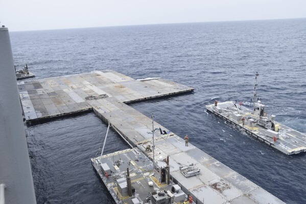 FILE - In this image provided by the U.S. Army, soldiers assigned to the 7th Transportation Brigade (Expeditionary) and sailors attached to the MV Roy P. Benavidez assemble the Roll-On, Roll-Off Distribution Facility (RRDF), or floating pier, off the shore of Gaza in the Mediterranean Sea on April 26, 2024. The pier is part of the Army's Joint Logistics Over The Shore (JLOTS) system which provides critical bridging and water access capabilities. (U.S. Army via Ǻ, file)