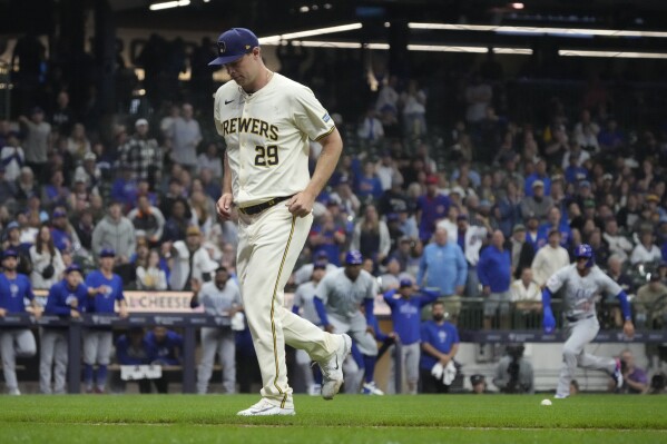 Milwaukee Brewers pitcher Trevor Megill walks off the field after being hit by a pitch as Chicago Cubs' Luis Vazquez rounds third and scores during the 10th inning of a baseball game Tuesday, May 28, 2024, in Milwaukee. (AP Photo/Morry Gash)