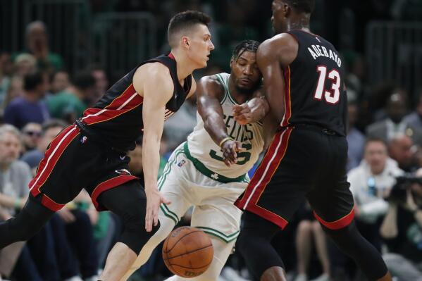 Miami Heat's Bam Adebayo (13) screens Boston Celtics' Marcus Smart (36) as Tyler Herro, left, drives   during the second half of Game 3 of the NBA basketball Eastern Conference finals playoff series, Saturday, May 21, 2022, in Boston. (AP Photo/Michael Dwyer)