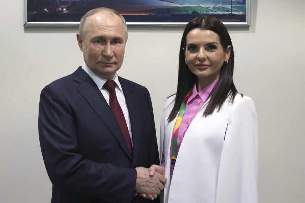 FILE - Russian President Vladimir Putin and Yevgenia Gutsul, the head of Moldova's autonomous region of Gagauzia, pose for a photo during the World Youth Festival at the Sirius Park of Science and Art outside Sochi, Russia, Wednesday, March 6, 2024. As Putin heads for another six-year term as Russia’s president, there’s little electoral drama in the race. What he does after he crosses the finish line, however, is what’s drawing attention and, for many observers, provoking anxiety. The country of Moldova is increasingly worried about becoming a Russian target. (Mikhail Metzel, Sputnik, Kremlin Pool Photo via AP, File)