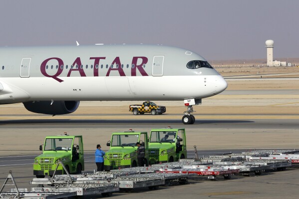 The first Qatar Airways plane in three years lands at King Khalid Airport in Riyadh, Saudi Arabia, Monday, Jan. 11, 2021.(AP Photo/Amr Nabil, File)