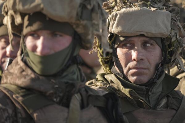 Ukrainian servicemen wait in formation before an exercise in the Joint Forces Operation, in the Donetsk region, eastern Ukraine, Tuesday, Feb. 15, 2022. While the U.S. warns that Russia could invade Ukraine any day, the drumbeat of war is all but unheard in Moscow, where pundits and ordinary people alike don't expect President Vladimir Putin to launch an attack on its ex-Soviet neighbor. (AP Photo/Vadim Ghirda)