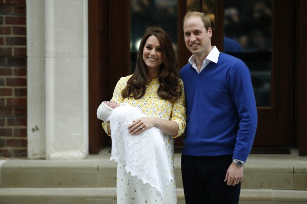 Britain's Prince William, right, and Kate, Duchess of Cambridge, hold their newborn daughter as they pose for the media outside the St. Mary's Hospital's exclusive Lindo Wing, London, Saturday, May 2, 2015. The Duchess gave birth to the Princess on Saturday morning. Attention on Princess Kate has reached levels not seen since she married Prince William in a fairy-tale wedding in 2011. An admission from Kate that she altered an official family photo triggered a backlash. (AP Photo/Alastair Grant)