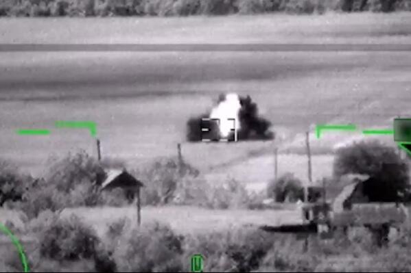 This image from video, released by the Russian Defense Ministry Press Service on June 6, 2023, shows what Russia claimed was the destruction of a German-made Leopard tank. But a visual analysis by The Associated Press shows the grainy black-and-white video Russia released to prove it had blown up the tanks actually documented the destruction of a tractor. (Russian Defense Ministry Press Service via AP)