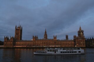 The Palace of Westminster viewed from the south side of the embankment by the River Thames just after dawn in London, Monday, Jan. 18, 2021. (AP Photo/Alastair Grant)