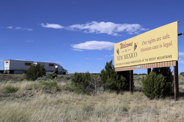 A Planned Parenthood of the Rocky Mountains billboard welcomes motorists to New Mexico on Interstate 40 near the Arizona border with a message that reads: "Our rights are safe. Abortion care is legal," on June 22, 2023. As more states pass abortion bans, providers and patients have flocked to New Mexico, a sanctuary for abortion rights. (Noel Lyn Smith/News21 via AP)