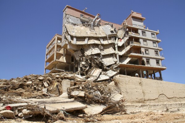 Damage from massive flooding is seen in Derna, Libya, Wednesday, Sept.13, 2023. Search teams are combing streets, wrecked buildings, and even the sea to look for bodies in Derna, where the collapse of two dams unleashed a massive flash flood that killed thousands of people. (AP Photo/Yousef Murad)