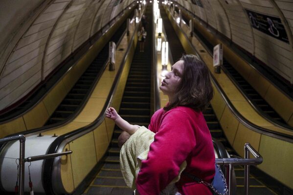 On Tuesday, June 10th, 2025, he calms his son down at a metro station during a Russian drone strike in Kiev, Ukraine.