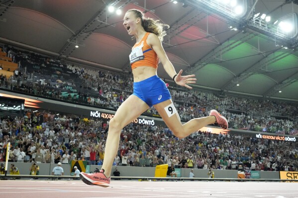 Femke Bol, of the Netherlands crosses the line to win the final of the Women's 4x400-meters relay during the World Athletics Championships in Budapest, Hungary, Sunday, Aug. 27, 2023. (AP Photo/David J. Phillip)