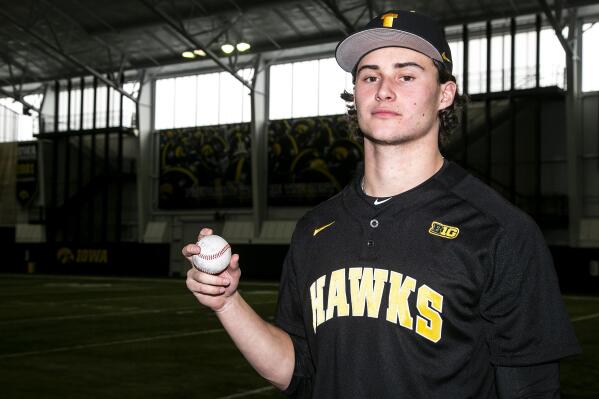 FILE - Iowa pitcher Brody Brecht poses for a photo during an NCAA college baseball media day, Feb. 10, 2022, at the University of Iowa Indoor Practice Facility in Iowa City, Iowa. The Iowa freshman is working double-duty this spring  as a pitcher on the baseball team and a wide receiver on the football team. (Joseph Cress/Iowa City Press-Citizen via AP, File)