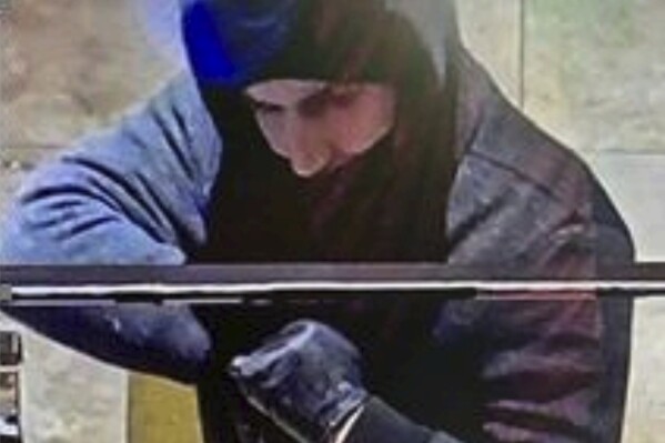 This photo provided by the Las Vegas Metropolitan Police Department shows a suspect captured by security cameras on Jan. 6, 2022, during a robbery at the Aliante hotel-casino in North Las Vegas. The police agency later identified the suspect as Caleb Rogers, who was employed as an active-duty patrol officer at the time of the robbery. Rogers is accused in a series of casino heists in Southern Nevada between November 2021 and February 2022, when he was arrested. His jury trial in U.S. District Court in Las Vegas is set to begin Monday, July 10, 2023. (Las Vegas Metropolitan Police Department via AP)