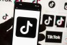 FILE - The TikTok logo is displayed on a mobile phone in front of a computer screen, Oct. 14, 2022, in Boston. A measure set to force TikTok's parent company to sell the video-sharing platform or face a ban in the U.S. received President Joe Biden's official sign-off on Wednesday, April 24, 2024. But the newly-minted law could soon face an uphill battle in court. (AP Photo/Michael Dwyer, File)