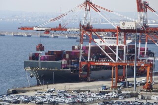 FILE - A container ship is loaded and unloaded at a container terminal at a port of Kawasaki near Tokyo on March 9, 2022. Japan has reported that its exports increased by 1.6% in October from a year earlier, as auto and ship shipments increased, according to government data released Thursday, Nov. 16, 2023. (AP Photo/Koji Sasahara, File)