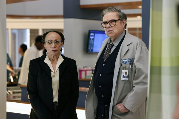 This image released by NBC shows S. Epatha Merkerson, left, and Oliver Platt in a scene from "Chicago Med." (George Burns Jr/NBC via AP)
