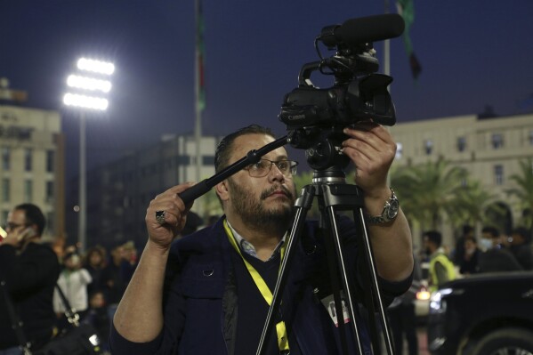 Libya video producer for The Associated Press Adel Omran films an event marking Libyan’s Independence Day on December 24, 2021 in Tripoli, Libya. Omran died Friday, Oct. 27, 2023 at 46 years old after suffering a heart attack in Port Said, Egypt. Omran led AP's video coverage of the uprising that turned into a prolonged civil war in Libya. He is remembered by many as a talented and caring colleague. (AP Photo/Yousef Murad)