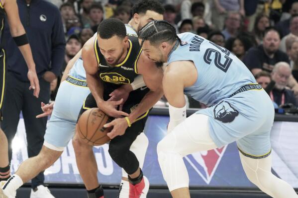 Memphis Grizzlies' Dillon Brooks (24) and Golden State Warriors' Stephen Curry (30) battle for the ball in the first half of Game 5 of an NBA basketball second-round playoff series Wednesday, May 11, 2022, in Memphis, Tenn. (AP Photo/Karen Pulfer Focht)