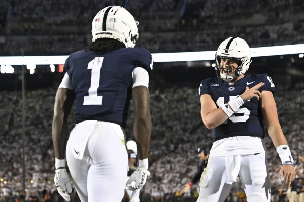 Penn State wide receiver KeAndre Lambert-Smith (1) celebrates after a touchdown pass with quarterback Drew Allar (15) during the second half of an NCAA college football game against West Virginia, Saturday, Sept. 2, 2023, in State College, Pa. (AP Photo/Barry Reeger)