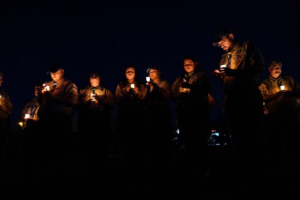 People gather at a vigil in Lisbon Falls, Maine, for the victims of this week's mass shootings, Saturday, Oct. 28, 2023. (AP Photo/Matt Rourke)
