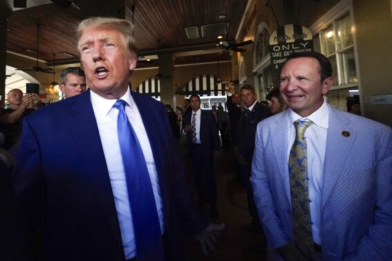 FILE - Former President Donald Trump, left, and Louisiana Attorney General Jeff Landry visit Café du Monde in New Orleans, July 25, 2023. Louisiana politics has been dominated so far this year by new Republican Gov. Jeff Landry's special legislative sessions to address crime and adopt new congressional maps, but the focus will shift briefly Saturday, March 23, 2024, to the state's presidential primaries. President Joe Biden and Trump both unofficially sewed up their parties' nominations last week and face little opposition on Louisiana's primary ballot. (AP Photo/Gerald Herbert, File)