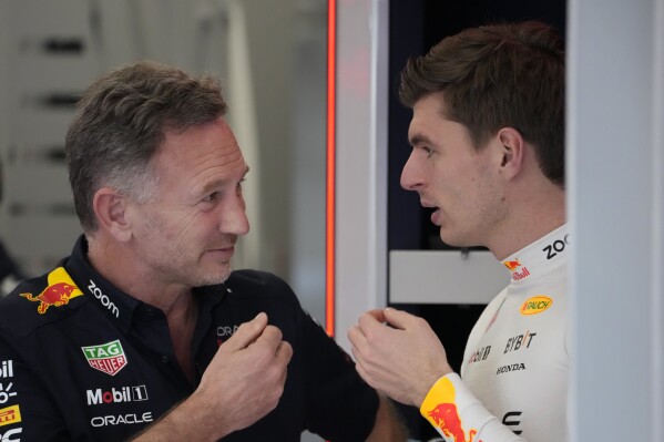 Red Bull team principal Christian Horner, left, speaks with Red Bull driver Max Verstappen of the Netherlands in the team's pit garage before the first practice session ahead of the Formula One Saudi Arabian Grand Prix at the Jeddah Corniche Circuit in Jeddah, Saudi Arabia, Thursday, March 7, 2024. The Saudi Arabian Grand Prix will be held on Saturday, March 9, 2024. (AP Photo/Darko Bandic)