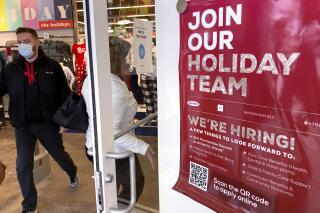 Holiday hiring sign is displayed at a retail store in Vernon Hills, Ill., Saturday, Nov. 13, 2021. The number of Americans applying for unemployment benefits fell for the seventh straight week to a pandemic low 268,000. U.S. jobless claims dipped by 1,000 last week from the week before, the Labor Department reported Thursday, Nov. 18. (AP Photo/Nam Y. Huh)