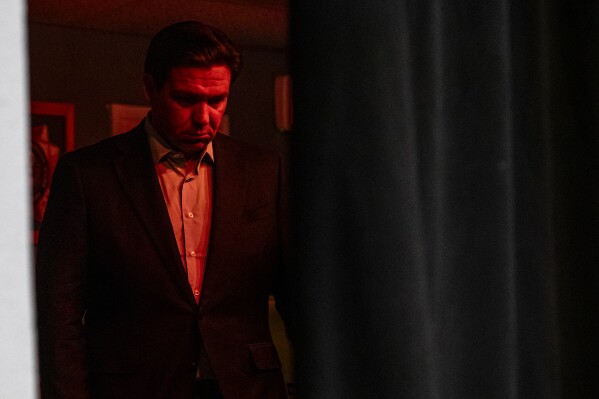 Florida Gov. Ron DeSantis waits backstage during a meet and greet event at VFW Post 788 in Cedar Rapids, Iowa on Tuesday, Dec. 19, 2023. DeSantis and Rep. Chip Roy, R-Texas, spoke to community members and held a question and answer session. (Nick Rohlman/The Gazette via AP)