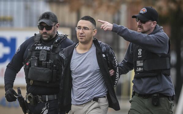 FILE - Solomon Pena, center, a Republican candidate for New Mexico House District 14, is taken into custody by Albuquerque Police officers, Jan. 16, 2023, in southwest Albuquerque, N.M. Two years since the attack on the U.S. Capitol, a series of drive-by shootings targeting Democrats in New Mexico is a violent reminder that the false claims about a stolen election persist in posing a danger to public officials and the country’s democratic institutions. No one was hurt in the Albuquerque attacks. (Roberto E. Rosales/The Albuquerque Journal via AP, File)