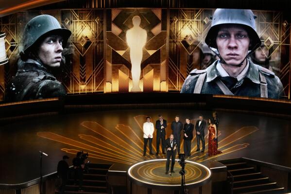 Edward Berger, front center, accepts the award for "All Quiet on the Western Front" from Germany, for best international feature film at the Oscars on Sunday, March 12, 2023, at the Dolby Theatre in Los Angeles. Standing from left are Daniel Bruhl, Malte Grunert, Albrecht Abraham Schuch, Felix Kammerer, Antonio Banderas and Salma Hayek. (AP Photo/Chris Pizzello)