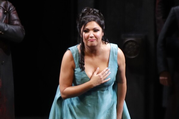FILE - Russian soprano Anna Netrebko bows to the audience at the end of La Scala opera house's gala season opener, Giacomo Puccini's opera "Tosca" at the Milan La Scala theater, Italy, on Dec. 7, 2019. Soprano Netrebko, once among the Metropolitan Opera’s biggest box office draws, sued the company and general manager Peter Gelb on Friday, Aug. 4, 2023, alleging defamation, breach of contract and other violations related to the institution's decision to drop her following Russia’s invasion of Ukraine. (AP Photo/Luca Bruno, File)