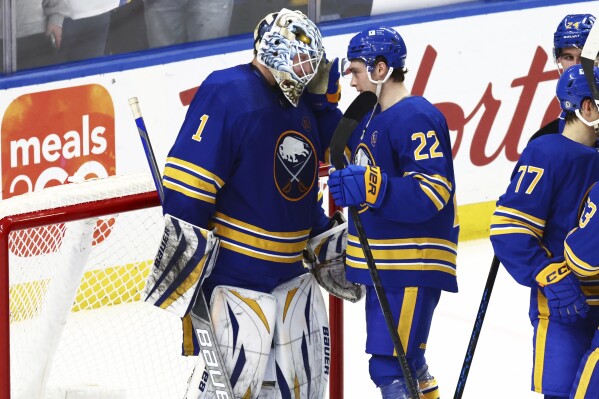 Buffalo Sabres goaltender Ukko-Pekka Luukkonen (1) and right wing Jack Quinn (22) celebrate after a victory in an NHL hockey game against the Washington Capitals, Thursday, April 11, 2024, in Buffalo, N.Y. (AP Photo/Jeffrey T. Barnes)