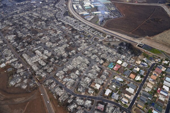 FILE - Wildfire wreckage is seen Thursday, Aug. 10, 2023, in Lahaina, Hawaii. With a housing crisis that has priced out many Native Hawaiians as well as families that have been there for decades, concerns are rising that Maui could become the latest example of “climate gentrification,” when it becomes harder for local people to afford housing in safer areas after a climate-amped disaster. (AP Photo/Rick Bowmer, File)