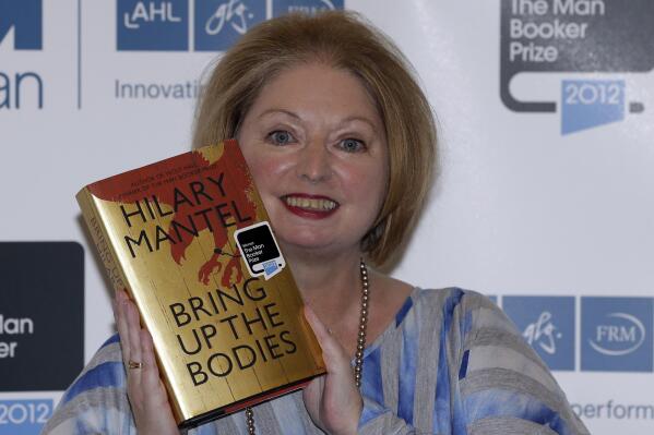 FILE - Hilary Mantel, winner of the Man Booker Prize for Fiction, poses with a copy of her book 'Bring up the Bodies', shortly after the award ceremony in central London, on Oct. 16, 2012. Mantel, the Booker Prize-winning author of the acclaimed “Wolf Hall” saga, has died, publisher HarperCollins said Friday Sept. 23, 2022. She was 70. (AP Photo/Lefteris Pitarakis, File)