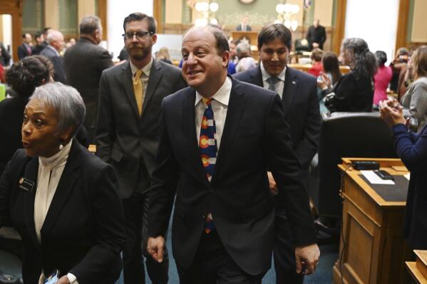 Colorado Gov. Jared Polis leaves the House of Representatives chamber after delivering his State of the State address to a joint session of the legislature in the State Capitol, Tuesday, Jan. 17, 2023, in Denver. (RJ Sangosti/The Denver Post via AP, Pool)
