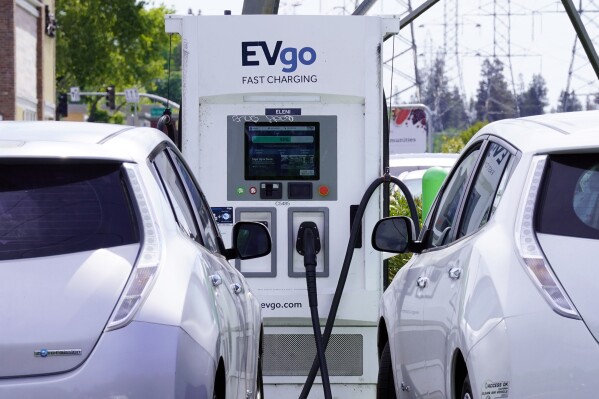 FILE — Electric cars are parked at a charging station in Sacramento, Calif., April 13, 2022. Connecticut's plan to halt the sale of new gas-powered cars by 2035 hit a speed bump, Tuesday, Nov. 28, 2023, after Gov. Ned Lamont pulled proposed regulations scheduled for a vote after it appeared there wasn't enough support. (AP Photo/Rich Pedroncelli, File)
