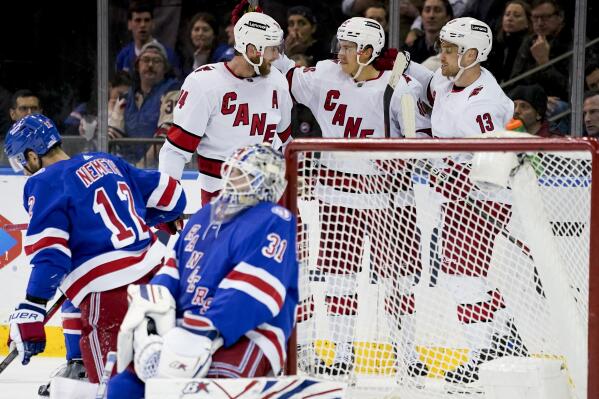 Carolina Hurricanes left wing Teuvo Teravainen, second from right, celebrates after scoring on New York Rangers goaltender Igor Shesterkin (31) during the second period of an NHL hockey game, Tuesday, April 26, 2022, in New York. (AP Photo/John Minchillo)