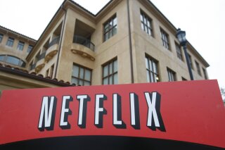 FILE - This Jan. 29, 2010, file photo shows the company logo and view of Netflix headquarters in Los Gatos, Calif. Netflix's normally lighthearted Twitter account took on a more somber tone on Saturday, May 30, 2020: "To be silent is to be complicit. Black lives matter. We have a platform, and we have a duty to our Black members, employees, creators and talent to speak up." (AP Photo/Marcio Jose Sanchez, File)