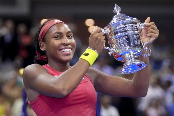 FILE - Coco Gauff holds up the championship trophy after defeating Aryna Sabalenka, of Belarus, in the women's singles final of the U.S. Open tennis championships, Saturday, Sept. 9, 2023, in New York. (AP Photo/Frank Franklin II, File)