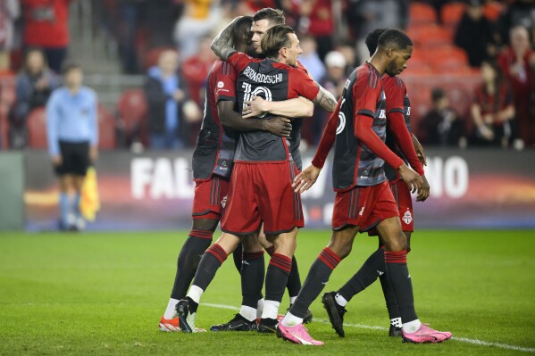 Toronto FC forward Federico Bernardeschi (10) celebrates with teammates after scoring against FC Dallas goalkeeper Maarten Paes during first-half MLS soccer match action in Toronto, Saturday, May 4, 2024. (Christopher Katsarov/The Canadian Press via AP)