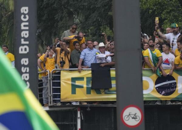 Brazilian President Jair Bolsonaro, center, wearing a blue shirt, attends a rally with thousands of his supporters, on Independence Day in Sao Paulo, Brazil, Tuesday, Sept. 7, 2021. (AP Photo/Andre Penner)
